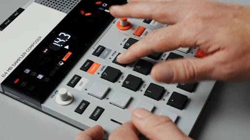 Person operating a digital music sampler and sequencer.