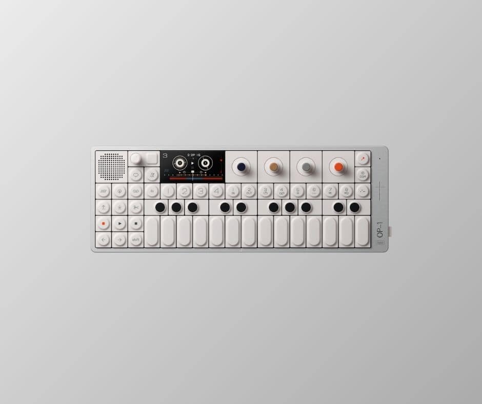 Compact portable synthesizer on grey background.